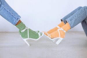 The Evolution of Socks - From Functional to Fashionable two ladies wear colorful socks